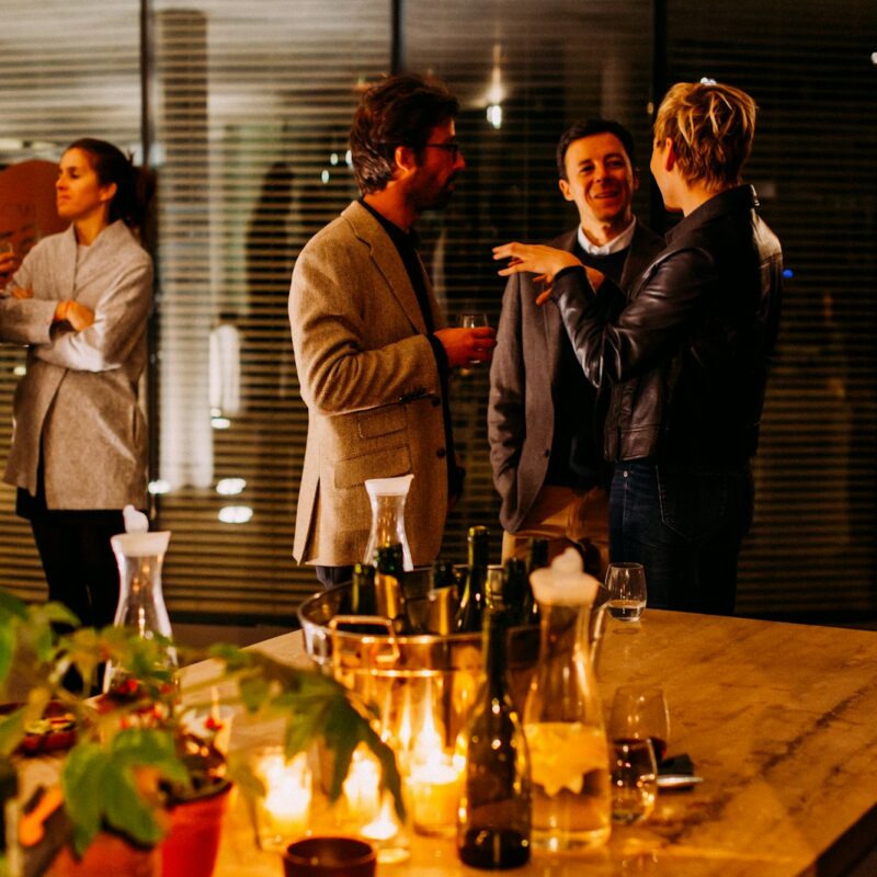 Small group of professionals networking and talking at a business event